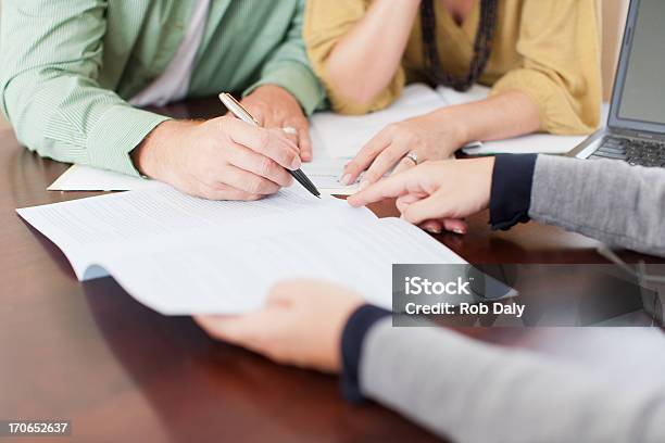 Couple Signing Contract Stock Photo - Download Image Now - Contract, Financial Loan, Document