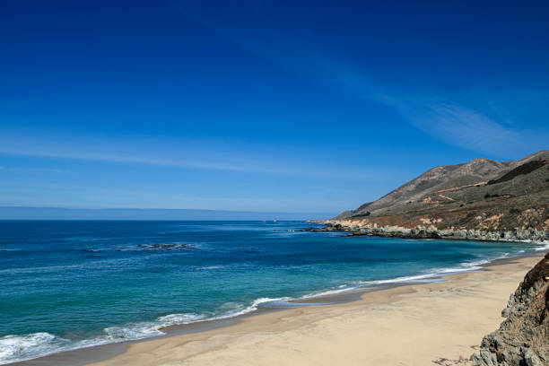 Wide view of waves crashing on shore rocks of Garrapata Beach.Taken at Garrapata Beach, Big Sur, California, USA