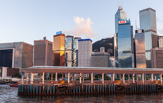 Hong Kong - July 11, 2017: Seaside view of Hong Kong central district, modern office skyscrapers in the evening