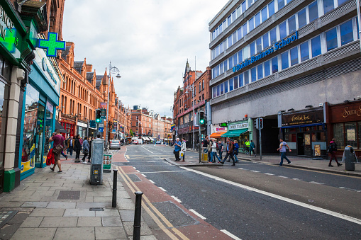 Dublin, Ireland - May 23, 2016. Pedestrians crossing a city street in downtown Dublin the capital of Ireland.