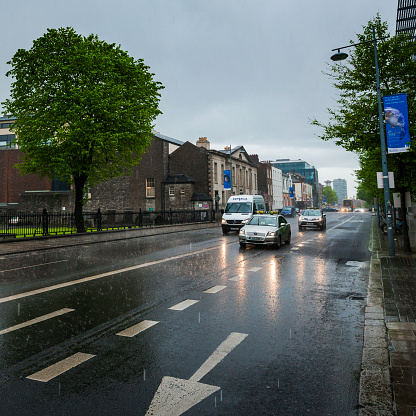 Dublin, Ireland - May 21, 2016. Traffic in the rain on a city street in downtown Dublin the capital of Ireland.