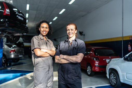 Portrait of auto mechanic women on a repair shop