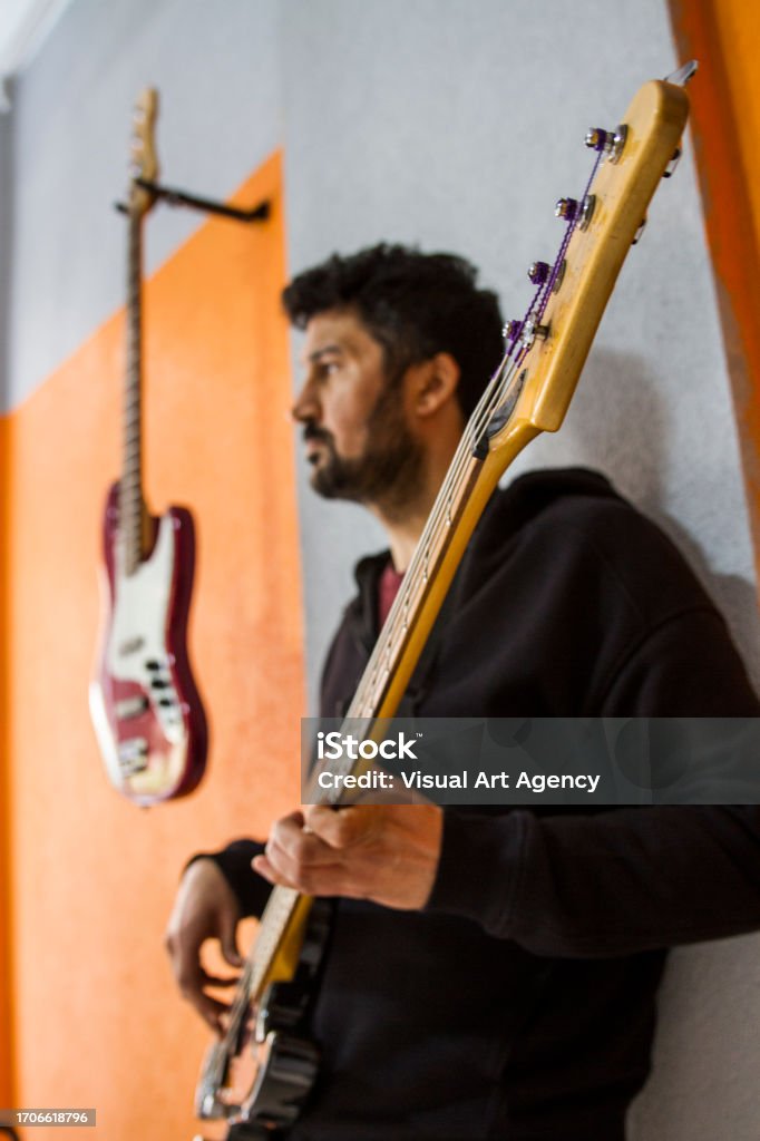 Side View Of Young Man Playing Guitar Guitarist Playing Guitar Concentratingly Adult Stock Photo