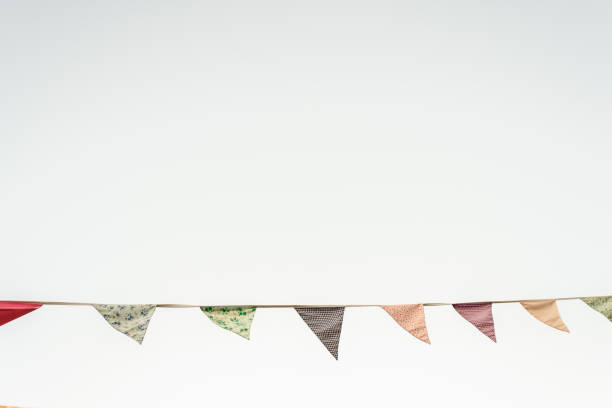 Vintage triangular pennants hanging with the blue sky in the background.