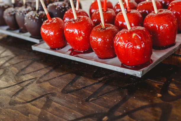 istock candy apple coated with red caramel candy for sale for kids. 1706623495