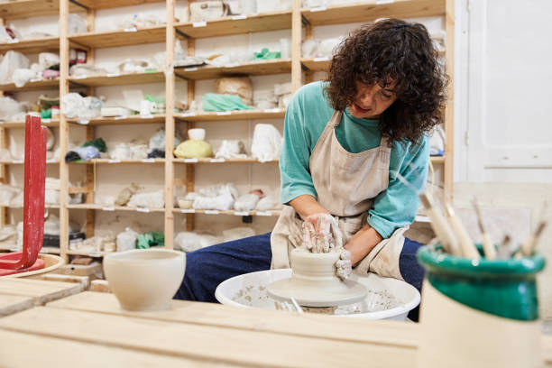istock Woman potter performing ceramic work on the potter's wheel. 1706638387