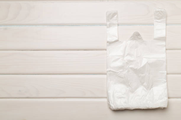 istock Plastic bag on wooden background, top view 1706639990