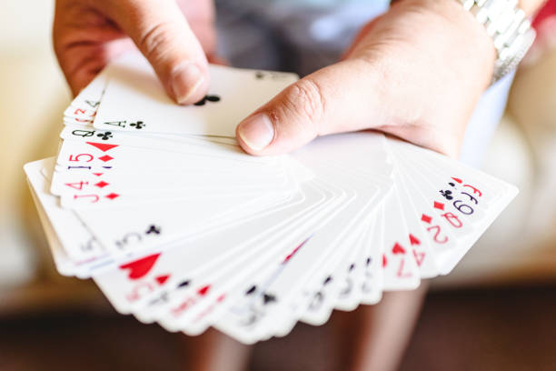 istock Magician hands doing magic trick with playing cards. 1706657969