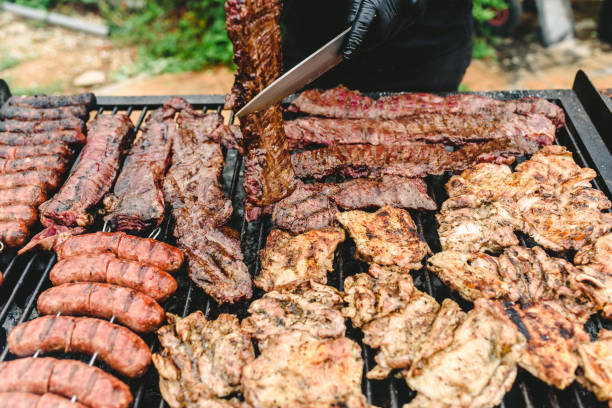 istock cook preparing grilled meat during a barbecue. 1706660716