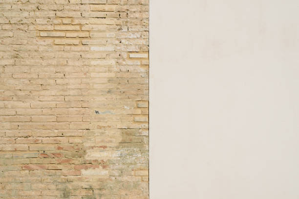 istock Background of a wall half white and half with bricks, divided into two halves. 1706661312