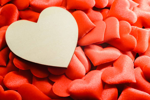 istock Large empty wooden heart surrounded by small red hearts for Valentine's Day, free space for text. 1706666039