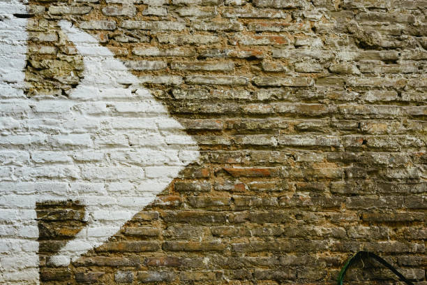 istock Brick wall with big white arrow indicating direction, background with copy space. 1706667086