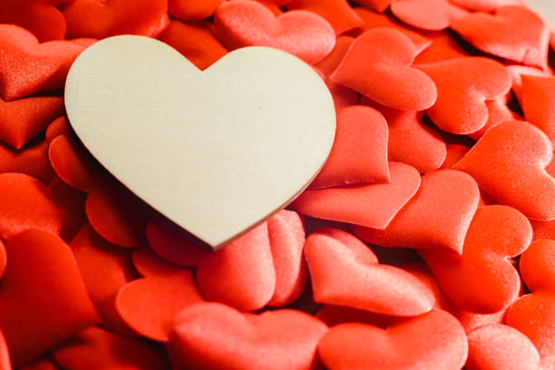 istock Large empty wooden heart surrounded by small red hearts for Valentine's Day, free space for text. 1706667628