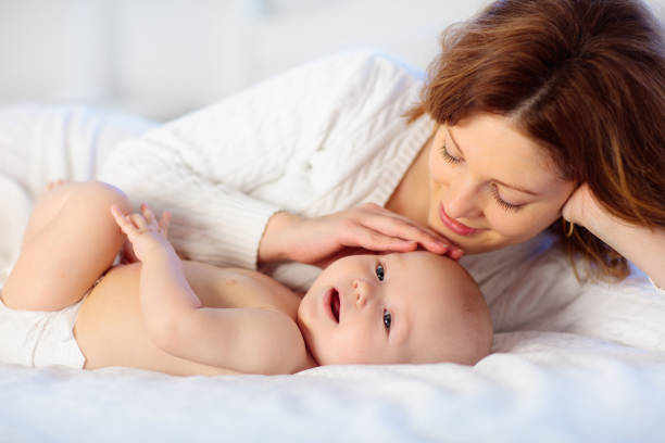 istock Mother and baby on a white bed 1706667763