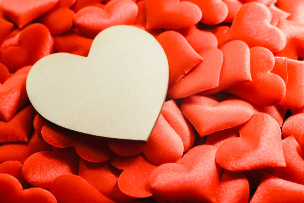 istock Large empty wooden heart surrounded by small red hearts for Valentine's Day, free space for text. 1706668385