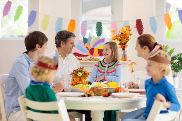 istock Family with kids at Thanksgiving dinner. Turkey. 1706670136