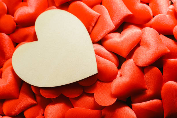 istock Large empty wooden heart surrounded by small red hearts for Valentine's Day, free space for text. 1706671206