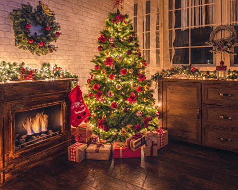 Decorated living room with Christmas tree near fireplace