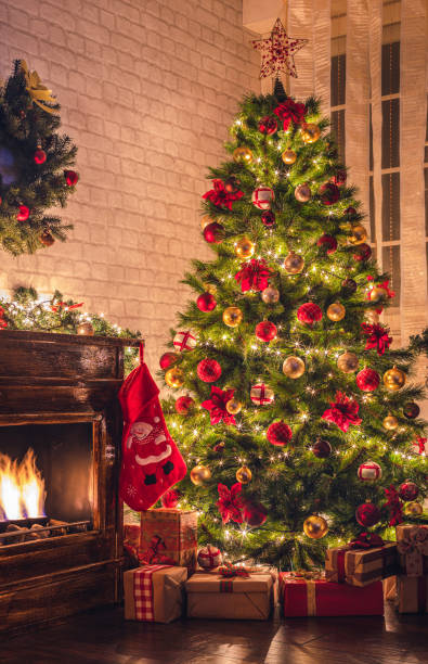 istock Decorated Christmas tree near fireplace at home 1706671717
