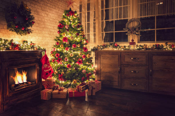 istock Decorated Christmas tree near fireplace at home 1706671723
