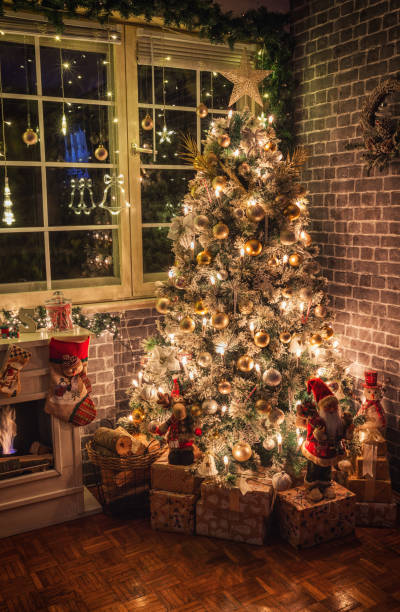 istock Decorated Christmas tree near fireplace at home 1706672013