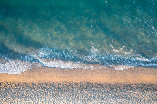istock Drone view of sandy beach with sea waves 1706687669
