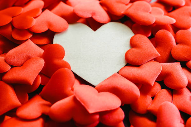 istock Large empty wooden heart surrounded by small red hearts for Valentine's Day, free space for text. 1706688685