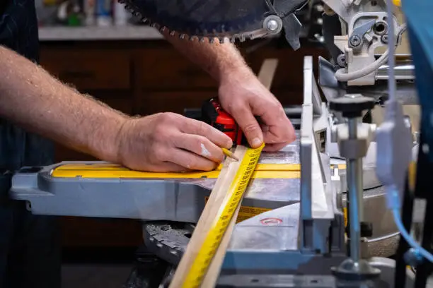 Cutting material on a skill-saw, measuring tape, carpentry