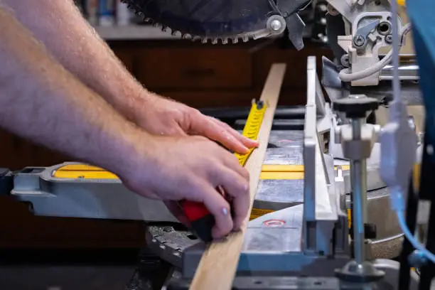 Cutting material on a skill-saw, measuring tape, carpentry