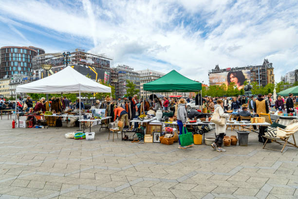Local Danish and tourists browse the vendors and kiosks selling gifts, antiques, collectibles and souvenirs at the Copenhagen City Hall Square in front of the City Hall building in Copenhagen, Denmark. Local Danish and tourists browse the vendors and kiosks selling gifts, antiques, collectibles and souvenirs at the Copenhagen City Hall Square in front of the City Hall building in Copenhagen, Denmark.  Its large size, central location, and affiliation with the city hall makes it a popular venue for a variety of events, celebrations and demonstrations. town hall square copenhagen stock pictures, royalty-free photos & images