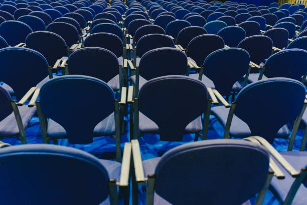 istock Many empty blue row chairs in a theater. 1706763248
