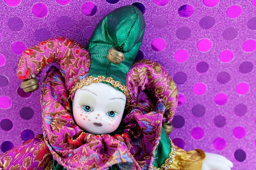 A close up of a vintage carnival prize clown doll toy,
