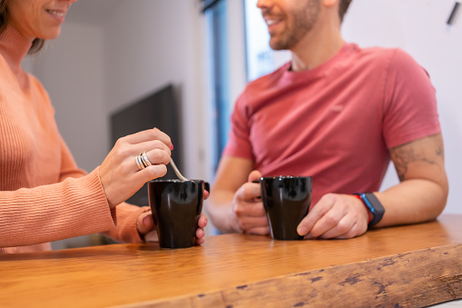 Close-up of a domestic scene of a couple drinking coffee and chatting