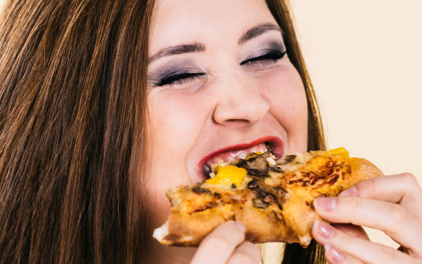 istock Woman eating hot pizza slice 1706779727