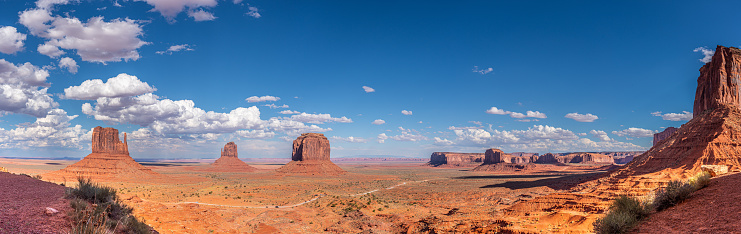 Monument Valley, on the Arizona - Utah border, gives us some of the most iconic and enduring images of the American Southwest.  The harsh empty desert is punctuated by many colorful sandstone rock formations.  It can be a photographer's dream to capture the ever-changing play of light on the buttes and mesas.  Even to the first-time visitor, Monument Valley will probably seem very familiar.  This rugged landscape has achieved fame in the movies, advertising and brochures.  It has been filmed and photographed countless times over the years.  If a movie producer was looking for a landscape that epitomizes the Old West, a better location could not be found.  This picture of the rock formations in the evening light was photographed from John Wayne Point near the Monument Valley Visitor Center north of Kayenta, Arizona, USA.