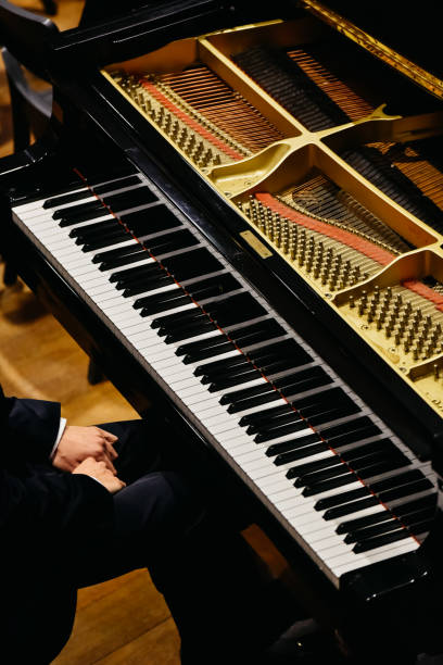 istock Hands of classical pianist playing his piano during a concert. 1706799385