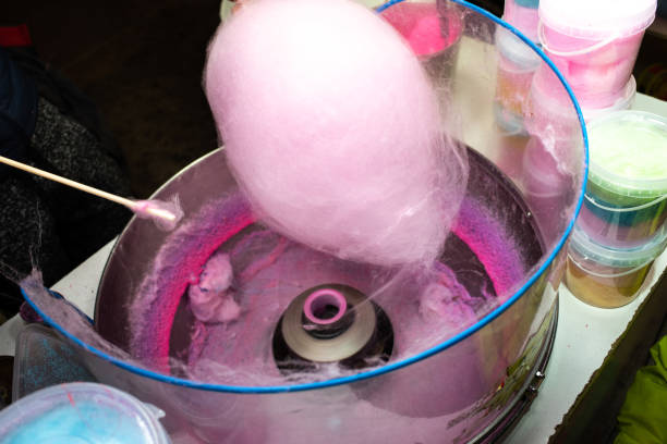 istock Machine to make cotton candy by turning and toasting the pink sugar. 1706812417