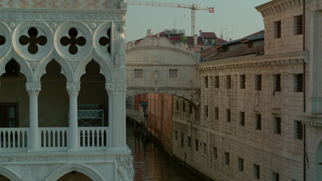 Aerial view of Venice, Italy at sunset, showing the Bridge Of Sighs and the Palazzo Dugale to a wide shot of St. Mark's Campanile. 4K stock video