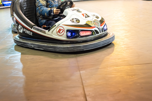 Valencia, Spain - December 14, 2018: Two children's bumper cars competing among them at an amusement park.