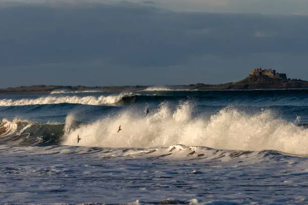 North Sea waves crash on the beach on the beautiful Northumberland coastline