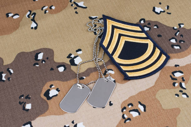 istock US ARMY Master Sergeant rank patch and dog tags on desert camouflage uniform 1706902169