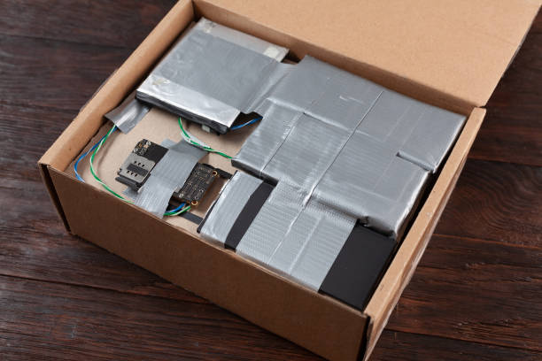 istock Hand made bomb with c4 and cell phone module in a cardboard box 1706905617