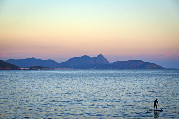 sylwetka wioślarza w zatoce guanabara o zmierzchu - rio de janeiro, brazylia - brazil silhouette sunset guanabara bay zdjęcia i obrazy z banku zdjęć