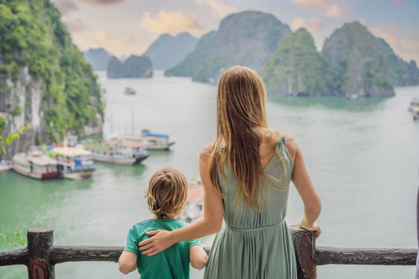 Mom and son travelers in Halong Bay. Vietnam. Travel to Asia, happiness emotion, summer holiday concept. Picturesque sea landscape. Ha Long Bay, Vietnam. After coronavirus COVID 19 stock photo