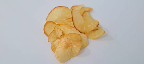 istock Heap deep fried cassava chips close up isolated on white background 1706906291