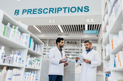 Working in a pharmacy - two male pharmacists