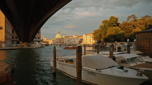 SLO MO Tourboats Moored on Grand Canal under Arch Bridge in Venice under Cloudy Sky
