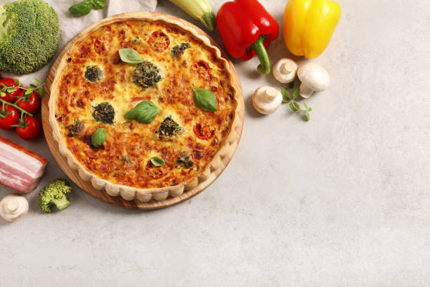 istock Delicious homemade quiche and ingredients on light gray table, flat lay. Space for text 1706965792
