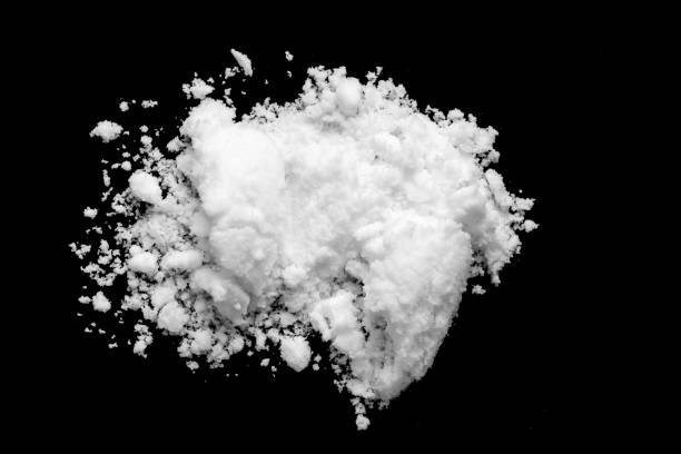 istock White snow isolated on black background close up 1706983186
