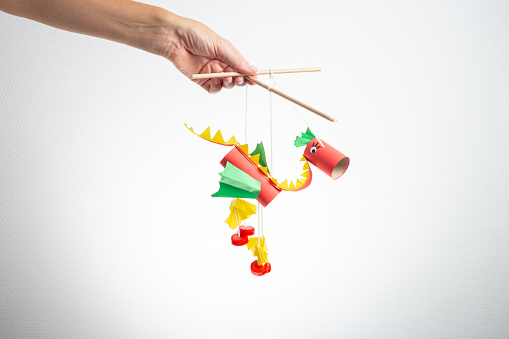 hand hold red dragon marionette, recycled craft, DIY, easy Chinese New Year Crafts and ideas for kids